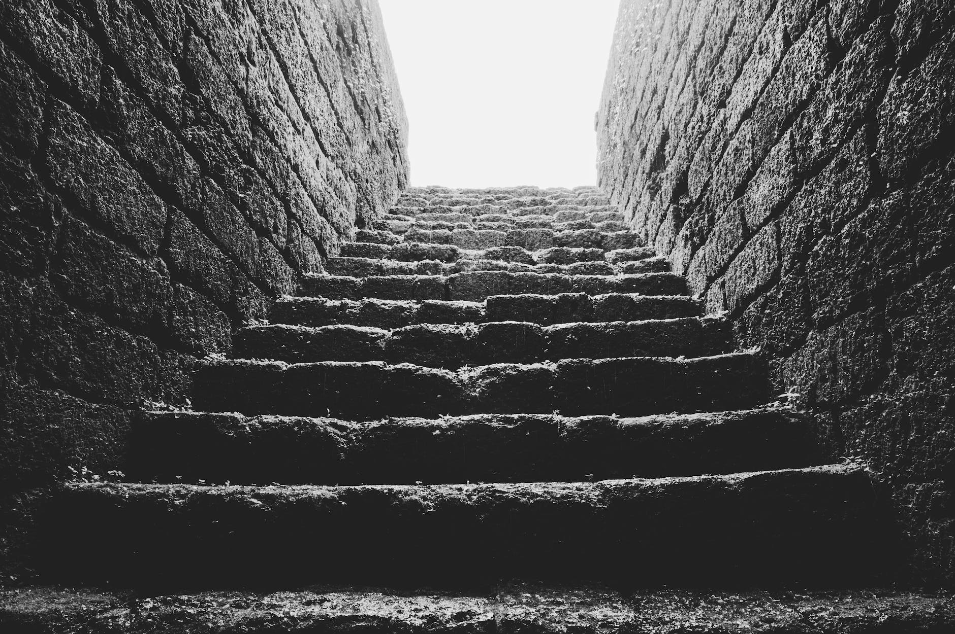 low angle grayscale photo of empty brick stairs