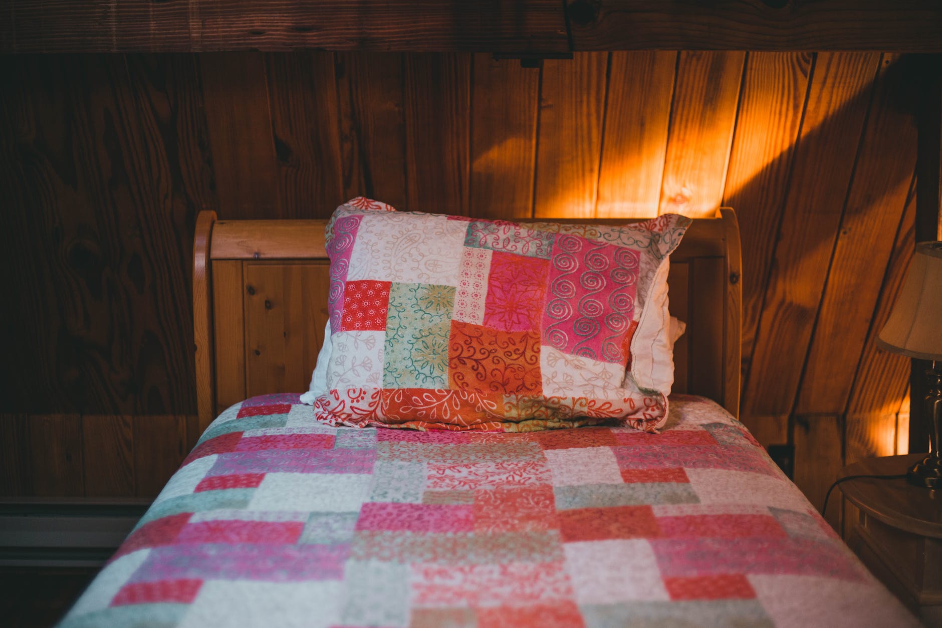a shot of a bed in wooden interior