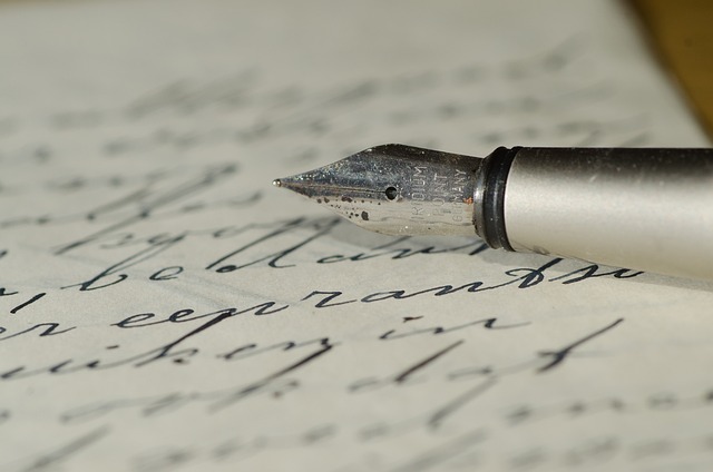 A fountain pen sitting on a piece of paper with handwriting on it.