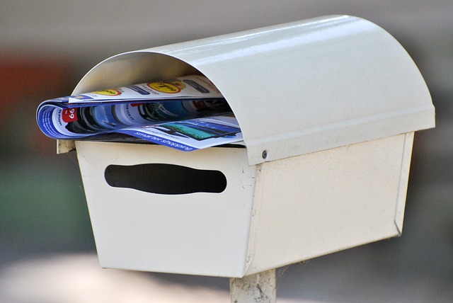 Marketing material stuffed into a mailbox.